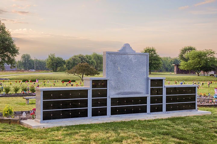 Sunset behind a planned resting place for ashes in a cemetery